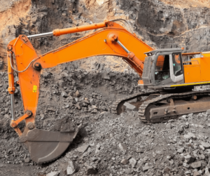 Orange excavator digging on a construction site. 