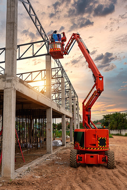 Orange aerial work platform on a construction site.